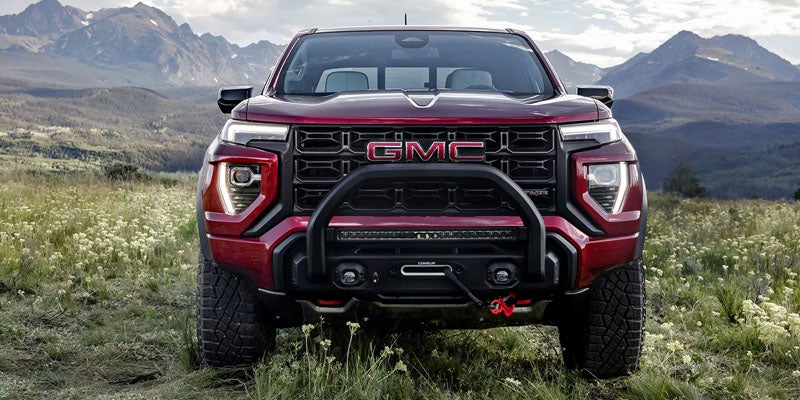 2026 GMC Canyon AT4X off-road truck on rugged terrain.