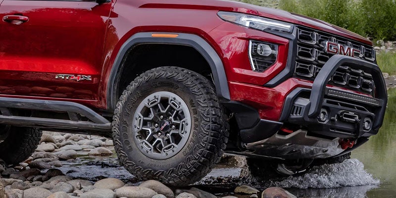 2026 GMC Canyon AT4X off-road truck on rocky terrain.