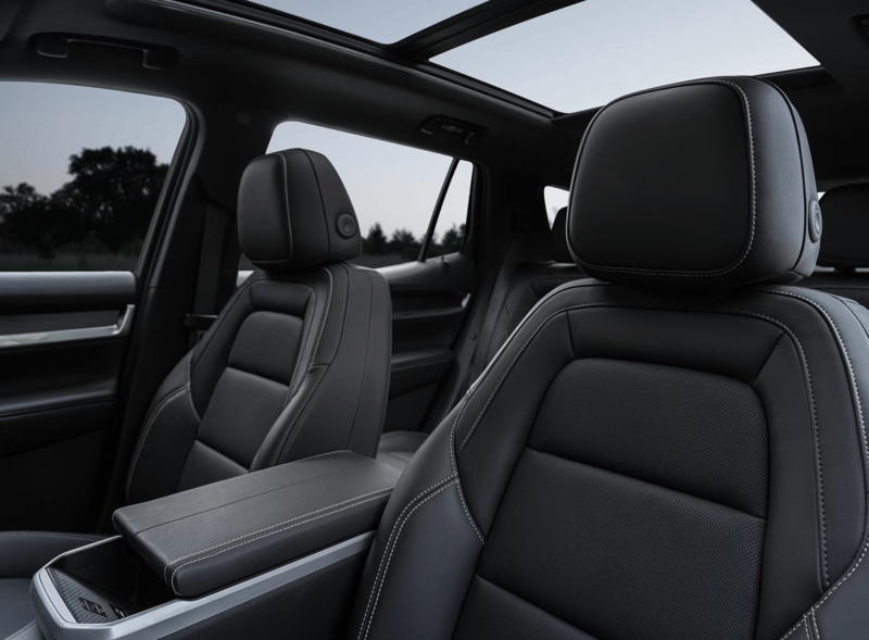 Interior of the 2027 GMC Terrain AWD featuring black leather seats, panoramic sunroof, and spacious cabin