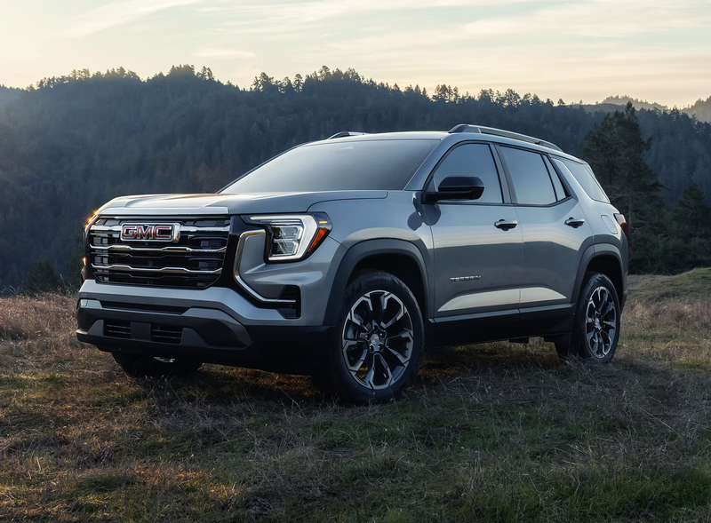 Front three-quarter view of the 2027 GMC Terrain AWD parked outdoors showcasing its bold grille and LED headlights.